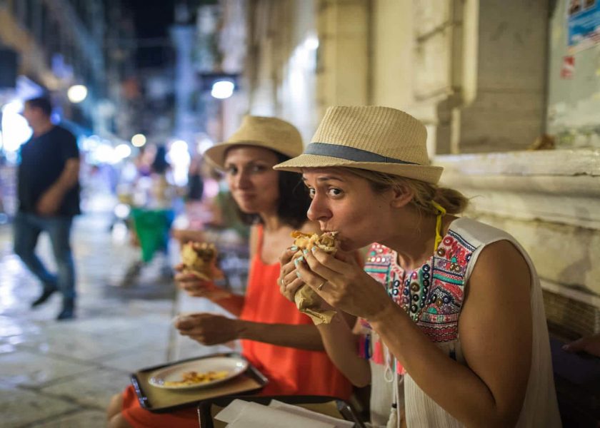 Hungry Young Tourists eating Gyros in Corfu town