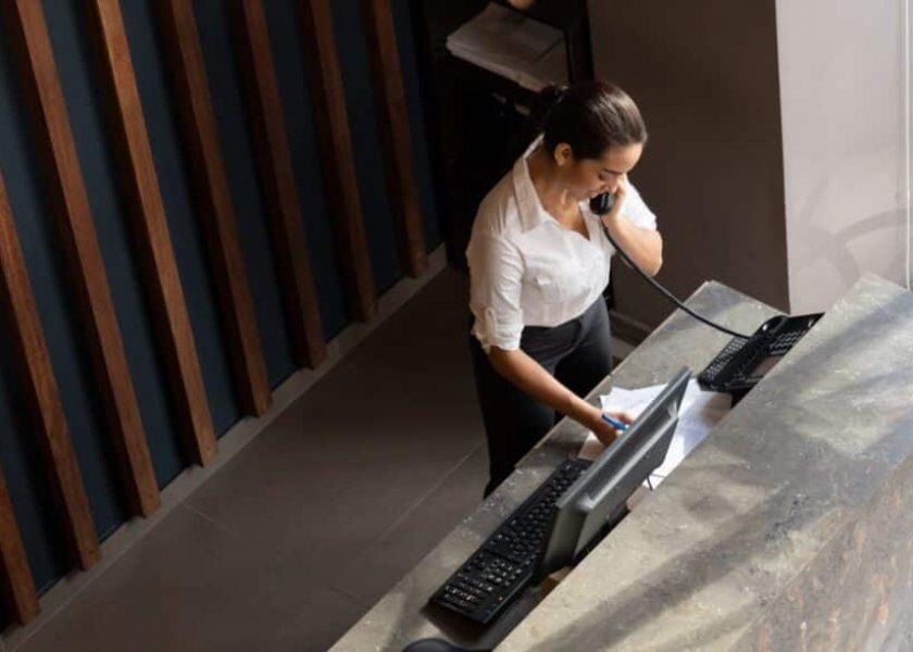 latin-american-hotel-receptionist-taking-a-phonecall-picture-id1068158520-1044×587